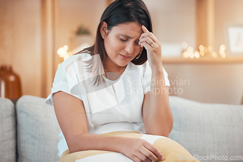 Image of Woman, stress and headache in pain on sofa from depression, anxiety or mental health issues at home. Sad female holding head suffering from mental illness, discomfort or loss on living room couch