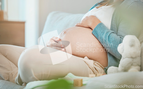 Image of Pregnant, stomach and mother bond with her baby while resting during maternity at home. Tummy, belly and pregnancy with a mommy to be holding her abdomen and caring for her kid while relaxing