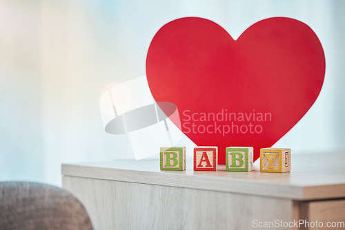 Image of Heart, sign and baby toy announcement for a kid, child or newborn on a family home table. Love, care and announce or notification in wooden building blocks design for colourful news with a shape