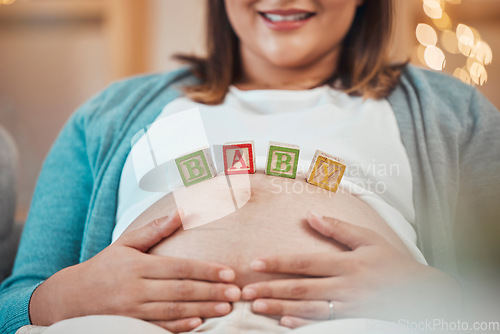 Image of Pregnant woman, hands and baby letter blocks for maternity, love and care holding tummy for soothing at home. Happy female smile touching stomach in pregnancy, mother to be or support for motherhood