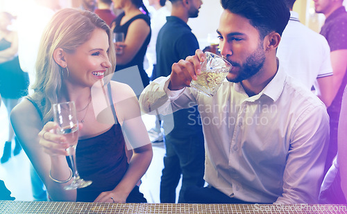 Image of Party, man and woman talking and drinking on a date to celebrate new years eve with dancing. Dating, partying and a couple of friends chat while celebrating at the disco with alcohol drinks