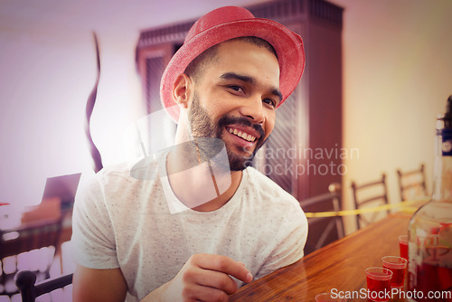 Image of Man, face and happy at new year, party and celebration with alcohol shots, drink and social with hat, fun and nightlife. Young male, celebrate or happiness while partying, spring break or house party