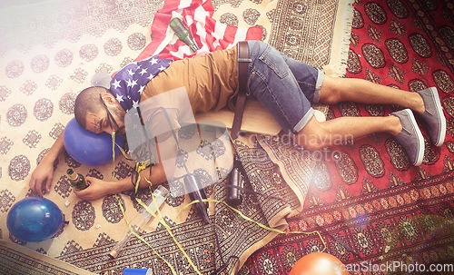 Image of Party, drunk and sleeping man after new years, social or drinking holiday event on a home carpet. Alcohol, celebrate and hangover of a tired person holding a beer bottle drink with addiction problem