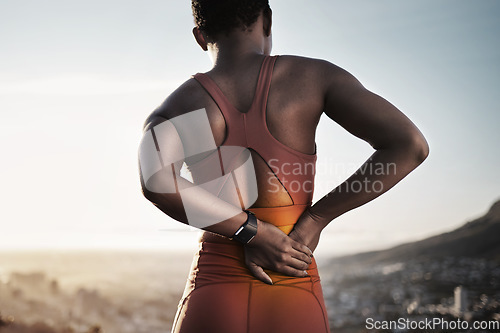 Image of Back pain, fitness and black woman with spine injury from outdoor sports training. Athlete with backache, joint pain and stress on body muscle from exercise, running and first aid health emergency