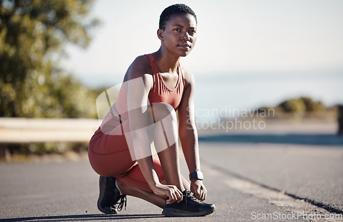 Image of Lace shoes, fitness and black woman woman on street for workout, running and wellness in Nigeria. Runner, sports athlete and girl tie sneakers for exercise, focus mindset and vision, health and goals