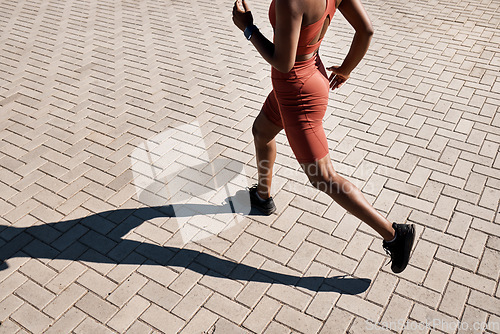 Image of Running, runner and woman with fitness in city, training for marathon and exercise with cardio workout in Seattle. Urban, run outdoor with health and wellness, active life and athlete shadow in sport