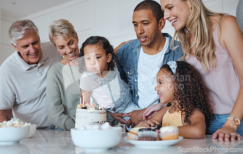 Image of Big family, birthday cake and blowing candles for a wish at home with parents, grandparents and children together for a celebration. Men, women and kids in UK house to celebrate at party for a girl