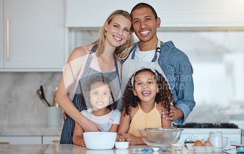 Image of Happy, smile and portrait of a family in the kitchen cooking together for a party, dinner or event. Happiness, love and interracial parents bonding and baking with their children in their modern home