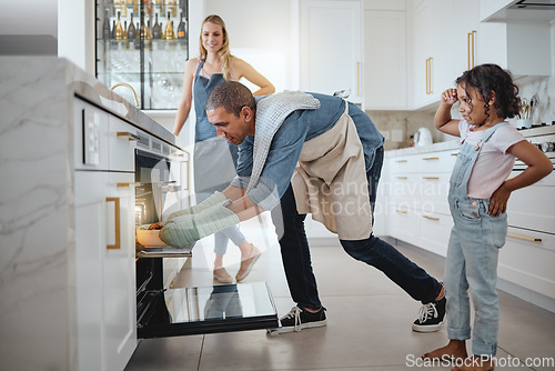 Image of Kitchen, family and father cooking in oven to prepare meal, lunch and food for supper with mother and girl. Family home, love and mom, dad and girl roast, cook and bake dish for festive celebration