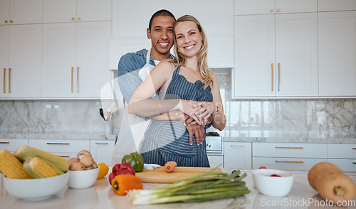 Image of Portrait, cooking and food with a couple in the kitchen together preparing a meal for lunch or supper in their home. Love, diversity and health with a man and woman making dinner while bonding