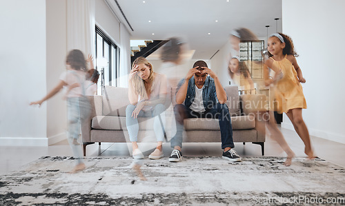 Image of Stress, headache and parents and running children in house living room or family home with adhd, mental health or hyper active energy. Mother, father or family with kids noise, autism or bad behavior