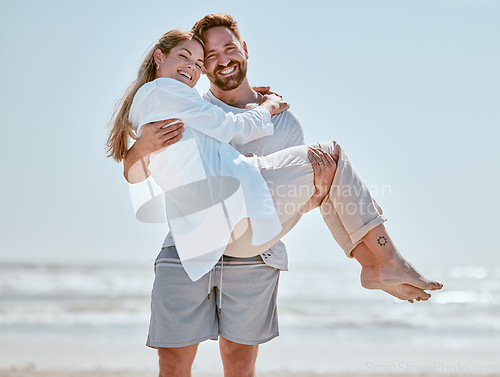 Image of Love, beach and man carrying his wife while on romantic vacation, adventure or trip in Australia. Romance, happy and portrait of happy couple with a smile in nature by ocean while on seaside holiday.