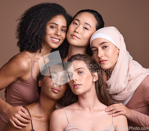 Image of Diversity, beauty and portrait of a group of women in studio for skincare, makeup or cosmetic routine. Feminism, female empowerment and face of multicultural girl friends isolated by brown background