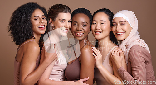 Image of Skincare, diversity and women hug portrait for inclusivity, happiness and healthy skin texture. Interracial beauty and model group with woman in hijab smile for cosmetic campaign in brown studio