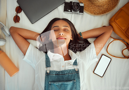 Image of Top view, relax and woman sleeping on bed at hotel on vacation, holiday or trip. Phone mockup, travel dream and happy female in bedroom at motel, resort or lodge with camera, laptop and headphones