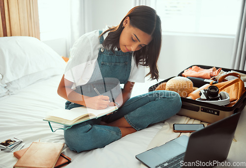 Image of Travel, planning and woman in bedroom with suitcase for summer, vacation or holiday information, checklist and website. Location, hotel and journal book of girl writing notes with clothes in luggage