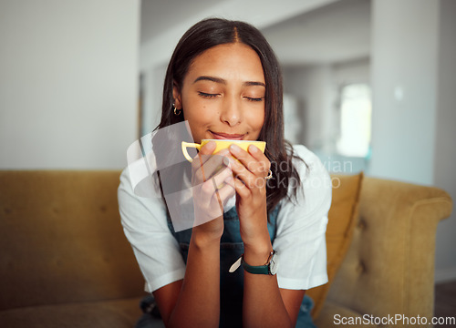 Image of Coffee, woman and morning drink on a home living room sofa feeling calm, relax and peace. House, tea and natural aroma of a person smelling and relaxing in a house with gratitude and happiness