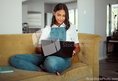 Image of Woman, laptop or relax on sofa in house or home living room for e learning, education or lockdown study. Smile, happy or student on technology for university homework, college or school scholarship