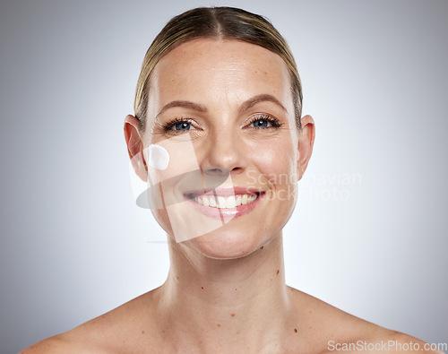 Image of Skincare, facial and portrait of woman with cream, lotion and skincare products on gray background studio. Spa, body wellness and face cream on female for dermatology, facial treatment and cosmetics