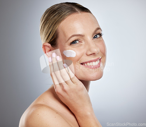 Image of Woman, skincare and cream for face on studio background with sunscreen, makeup product or luxury beauty cosmetics. Portrait of happy model, facial lotion and natural dermatology, aesthetic and health