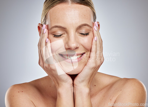 Image of Skincare glow, beauty and woman with self care, marketing wellness and dermatology against a grey studio background. Happy skin, cosmetics and face of a model advertising self love, grooming and spa