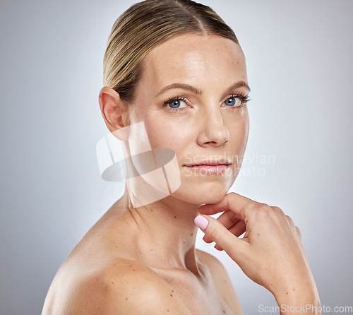 Image of Health, beauty and natural portrait of woman with clean, hydrated and glowing skin aesthetic. Dermatology, skincare and confident cosmetic model feeling beautiful face in gray studio.