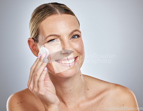 Image of Skincare, cotton and portrait of woman in studio for cleaning, wellness and makeup removal on grey background. Face, skin and girl model with cotton pad for facial, wellness and cosmetic beauty