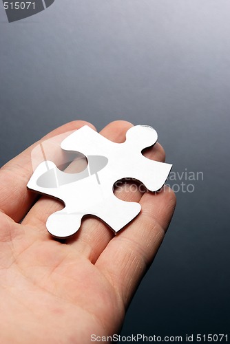 Image of Hand holding a puzzle piece