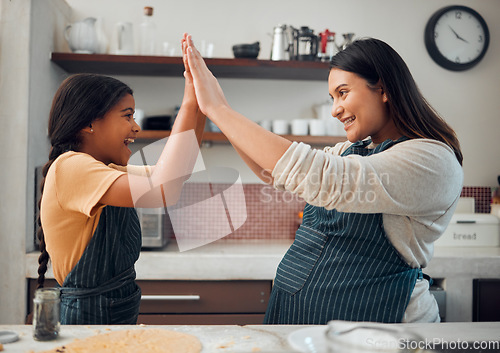 Image of Cooking, high five and success with mother and girl in kitchen for cookies, bonding and pregnancy. Help, happiness and achievement with pregnant woman baking with daughter for support, food and goal