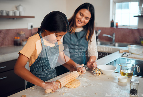 Image of Mom, girl and kitchen for teaching, rolling pin or cookies for baking, bonding love and family home. Mama, daughter and cooking for learning support, holiday or celebration for festive party in house