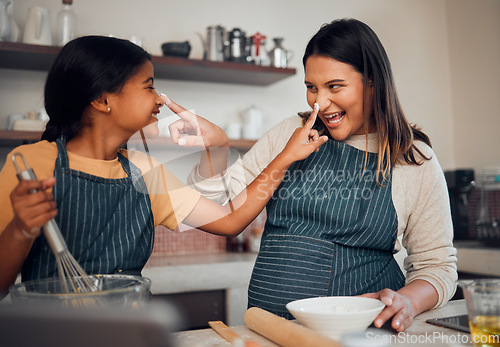 Image of Mother, girl and cooking while playing with flour, having fun or bonding. Learning, education and happy child chef with caring mom baking pastry, smiling and enjoying time together with dough on nose