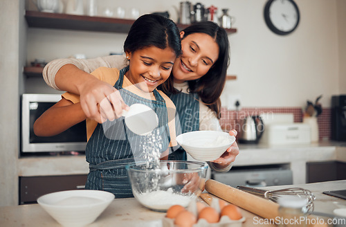 Image of Family, baking and helping with food in home kitchen with mother and daughter learning to make dessert with wheat flour and eggs. Happy woman teaching girl kid about cooking for fun bonding