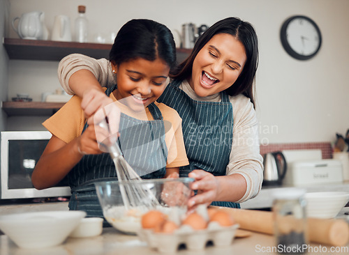 Image of Mom, kid and baking in kitchen, family home and house for childhood fun, learning or development. Mother and daughter cooking, teaching and mixing ingredients in bowl to bake dessert, flour and whisk