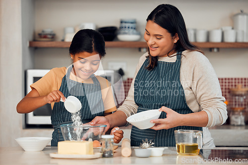 Image of Mother, girl and learning cooking in kitchen, bonding or having fun. Love, care and happy mama teaching kid chef baking, mixing flour in bowl and smiling while enjoying quality time together in house