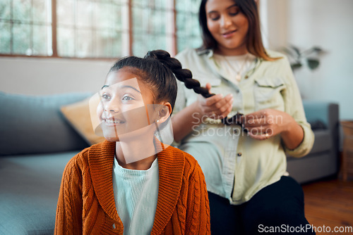 Image of Mom, girl and hair care in living room for bonding, love and care by sofa with happiness in home. Hair, mother and daughter for hairdresser, pony tail or helping hand with grooming for kid in Atlanta