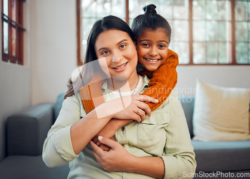 Image of Family, portrait and mother with girl on a sofa embrace, relax and smile in their home together. Face, mom and child hugging on a couch, enjoying bond, weekend and quality time in a living room