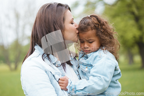 Image of Love, park and mother kiss child with upset, sad and unhappy expression on face for leaving playground. Family, support and mom kissing young girl for compassion, comfort and console her in nature