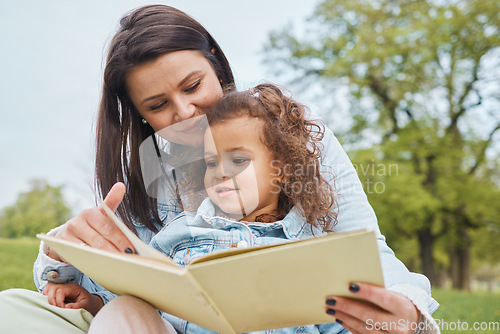 Image of Mother, girl book and reading in park for storytelling, development and relax for bonding together. Mom, female child and learning with story, education or love in garden, nature or backyard in Miami
