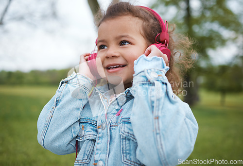 Image of Music, smile and baby in a park with headphones, radio freedom and streaming audio in Portugal. Podcast, happy and face of a boy child listening to a song for happiness, joy and cheerful in nature