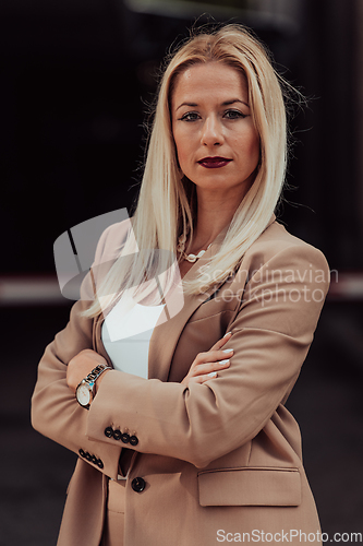 Image of A powerful portrait of a businesswoman, standing confidently with her arms crossed, representing the determination of the female gender and embodying strength and success