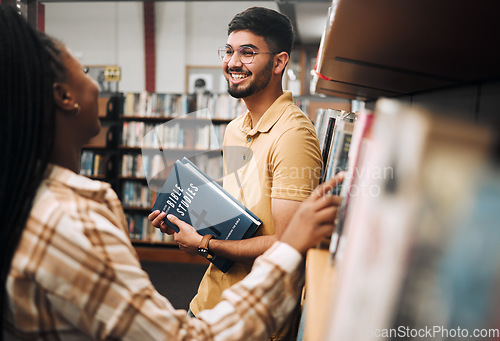 Image of Talking students, bonding and library bookshelf on school, college and university campus for education, learning and religion studying. Smile, happy man and black woman friends with textbook research