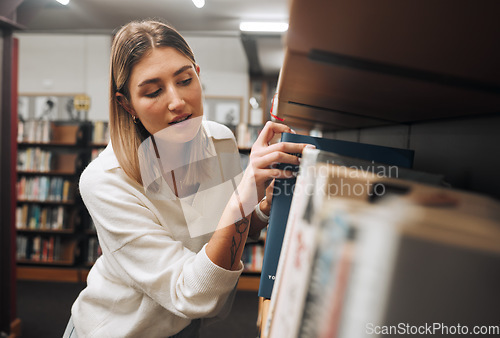 Image of Girl, student and search books in library for education, knowledge and learning. Young woman, university student and bookshelf at college campus for reading, studying and literature research analysis