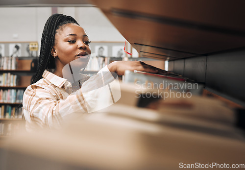 Image of Black woman, library shelf and books for reading, student knowledge or education development at university. African woman, young college girl and learning, study or university research at bookstore