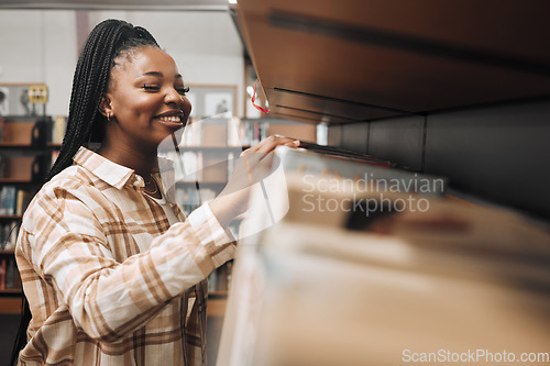 Image of Student, checking or library bookshelf on school, college or university campus for education, learning or studying. Smile, happy or excited black woman in textbook search, research or retail shopping