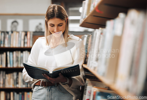 Image of Happy, reading or student in library for books, educational knowledge or research for learning or assessment. School girl, college or university student studying for insight or scholarship on campus