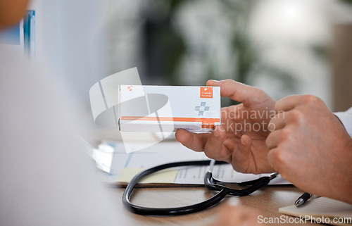 Image of Hand, doctor and pills for healthcare, medicine and treatment in office with patient closeup. Hands, medication and box by medical expert for prescription, health and recovery during hospital consult