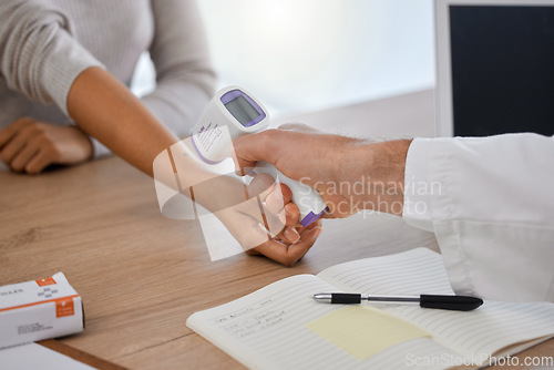 Image of Covid, thermometer and doctor consulting with woman for fever, temperature and healthcare, hospital and compliance. Hands, digital scan and patient with doc for corona screening in consultation room