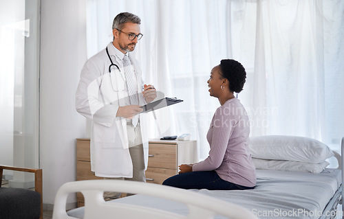 Image of Consulting, medical and doctor with black woman in hospital for checklist, examination and therapy. Appointment, interview and help with healthcare worker listening to patient for physician checkup