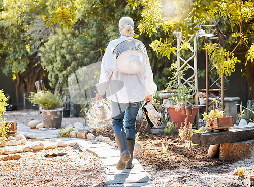 Image of Beekeeping, smoke for bees and woman in garden walking with farming equipment, gear and protective suit. Agriculture, nature and senior lady ready to harvest natural, organic and fresh honeycomb