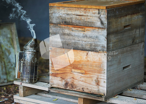 Image of Wooden box, smoke or beekeeper equipment on sustainability agriculture, countryside environment nature honey farm. Smoking tool, honeycomb container or bees production management for food collection